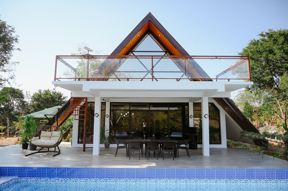 Front view of The Frame A-frame cabin with swimming pool