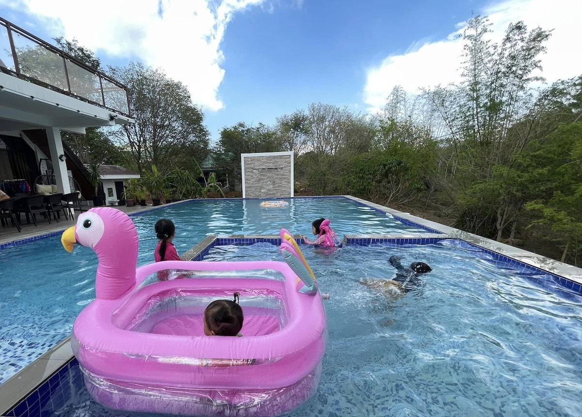 Guests enjoying the swimming pool with flamingo floats