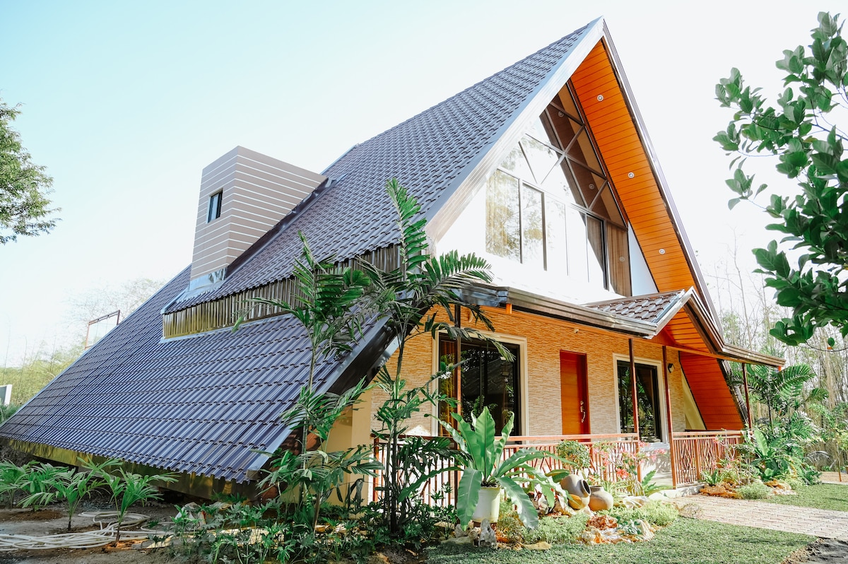 The Redwood Cabin exterior with lush tropical landscaping